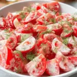 Fresh tomato garlic salad with ripe tomatoes, garlic dressing, and herbs, ideal for summer meals.